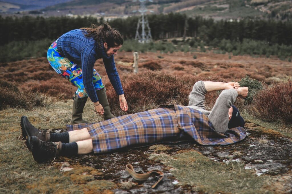 Scottish Great Kilt - Man lying on the ground having a kilt wrapped around him