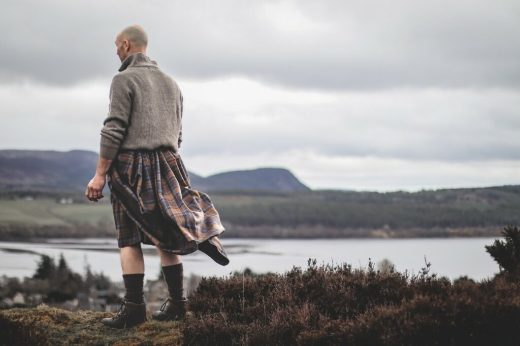 Scottish Great Kilt - Man in a kilt over looking the loch