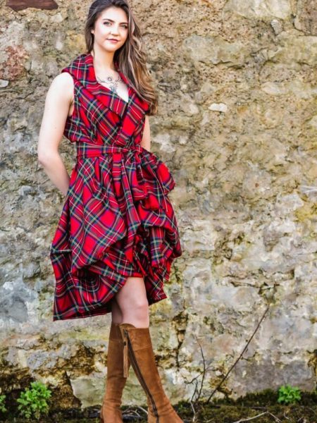 Contact Us Red tartan dress Contact us - Girl standing in front of a wall wear an red tartan dress