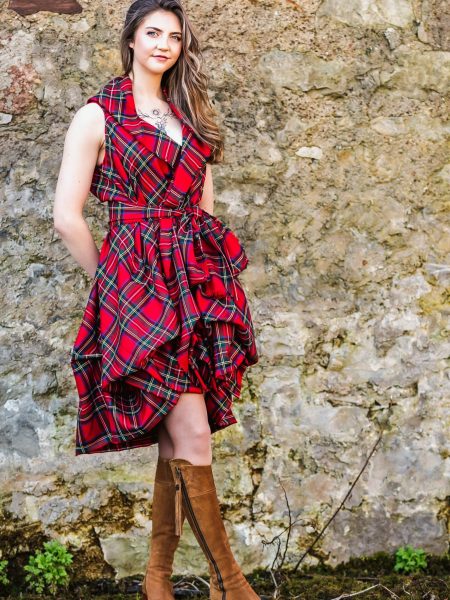 Contact Us Red tartan dress Conatct us - GGirl standing in front of a wall wear an red tartan dress